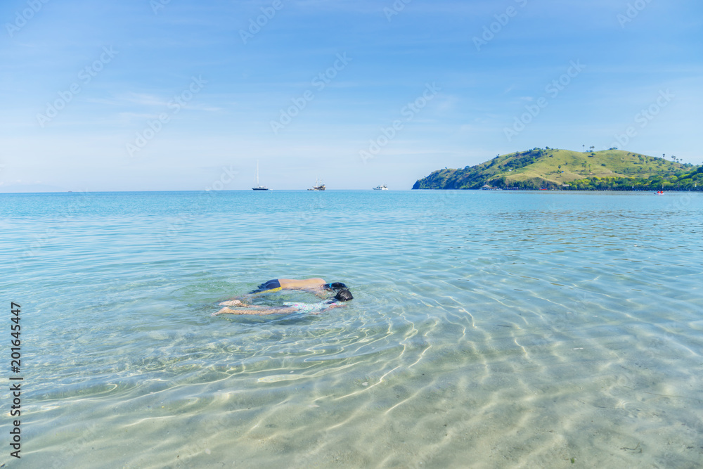 Two little children snorkeling on the tropical beach Two little children snorkeling on the tropical beach