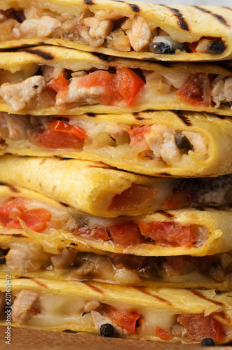 Quesadilla with chicken, tomatoes, mushrooms. Close up
