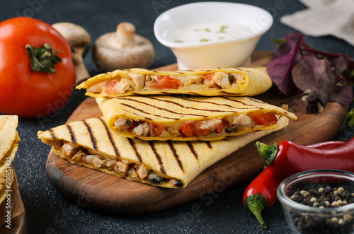 Mexican traditional food: chicken quesadilla with tomatoes