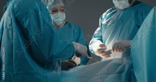 MED Medical team, doctors performing surgical operation in real modern operating theater. 4K UHD 60 FPS SLO MO photo