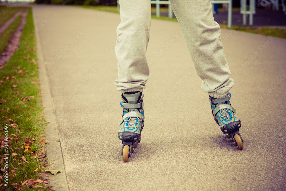 Human legs rollerblading wearing sportswear. Human legs rollerblading wearing sportswear.