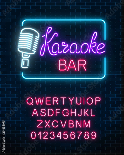 Neon signboard of karaoke music bar with alphabet. Glowing street sign of a nightclub with live music.