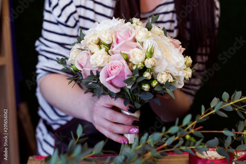 Florist makes bouquet for wedding.
