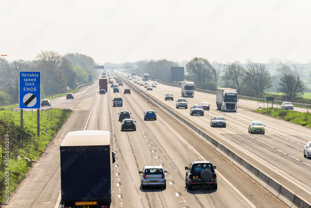 Sunny day view of UK motorway traffic - obrazy, fototapety, plakaty 