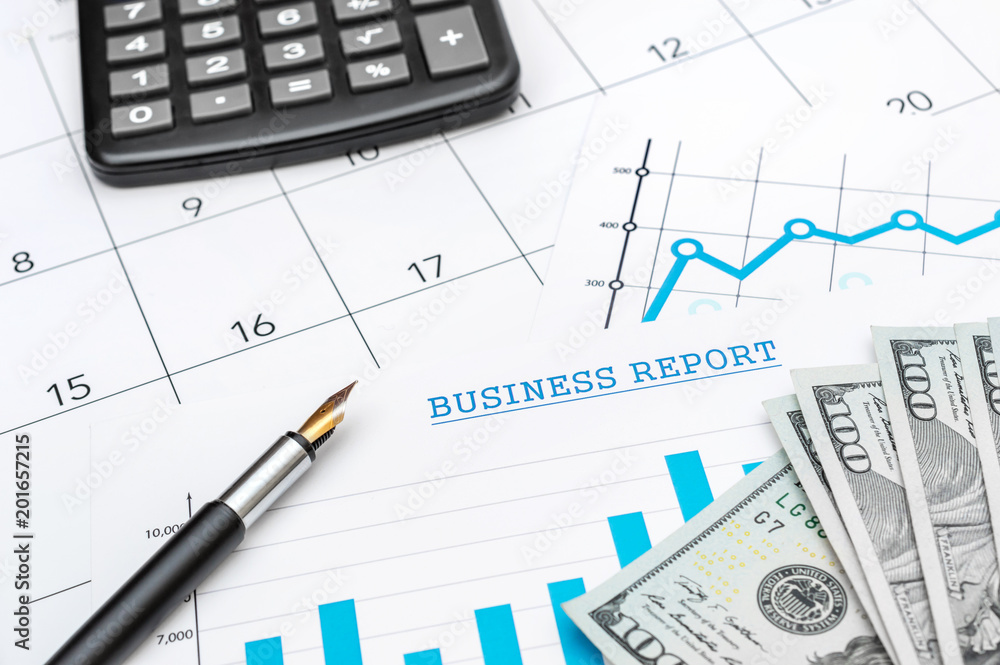 Business concept. Calculator, pen and money on the financial graphs. Business concept. Calculator, pen and money on the financial graphs.