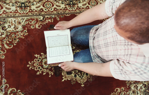 Muslim man reading Islamic holy book quran