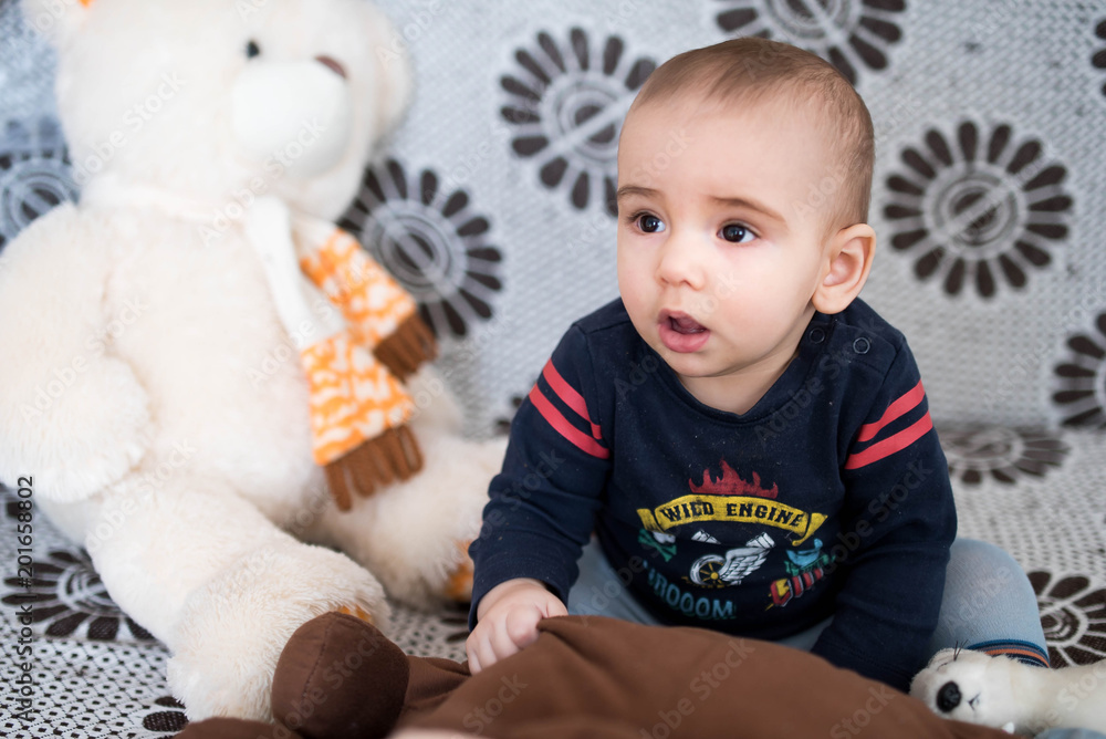 Little baby boy sits on sofa and plays with toys Little baby boy sits on sofa and plays with toys