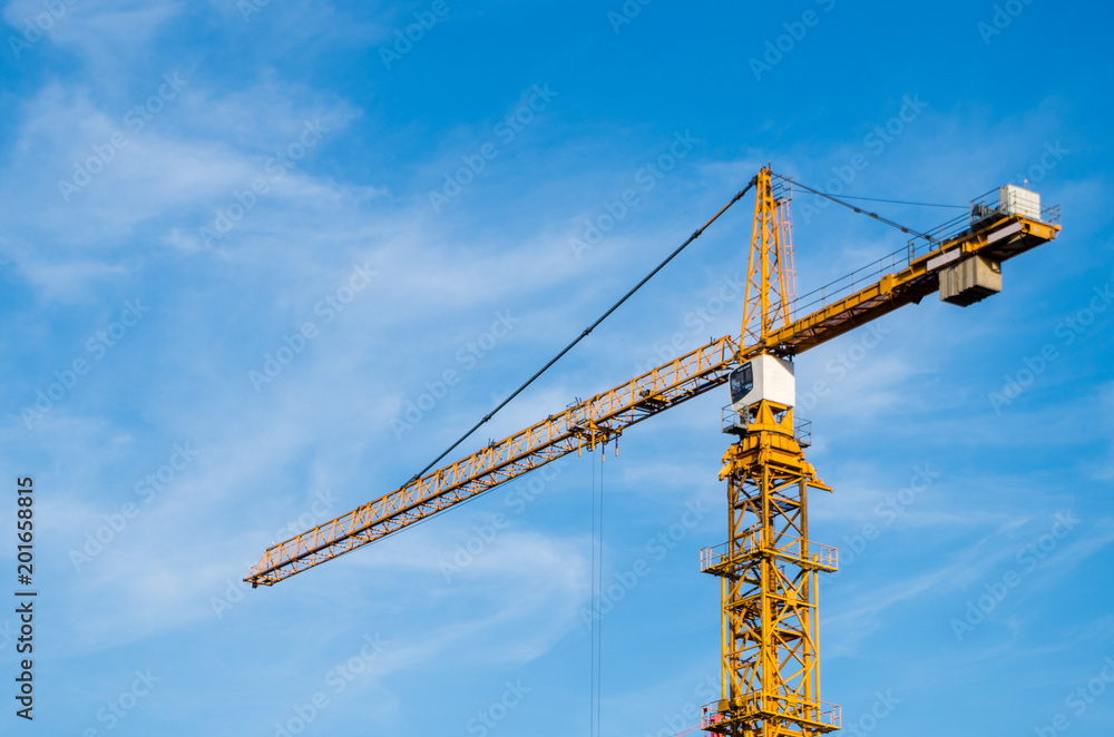 Orange crane against blue clear sky, copy space Orange crane against blue clear sky, copy space