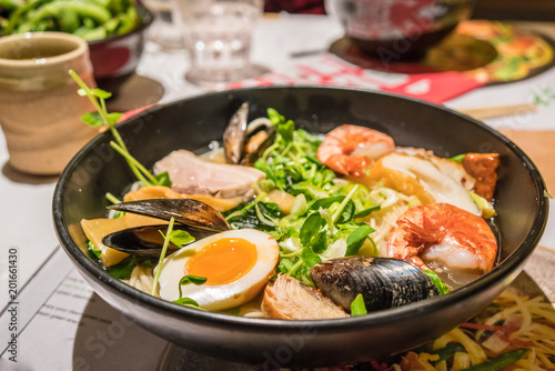 A large bowl of Japanese Ramen with egg  meat  prawn  mussel and vegetable