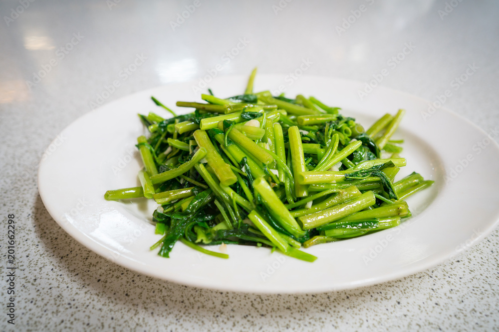 A plate of stir fry water spinach or kang kong A plate of stir fry water spinach or kang kong