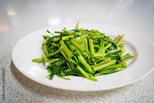 A plate of stir fry water spinach or kang kong