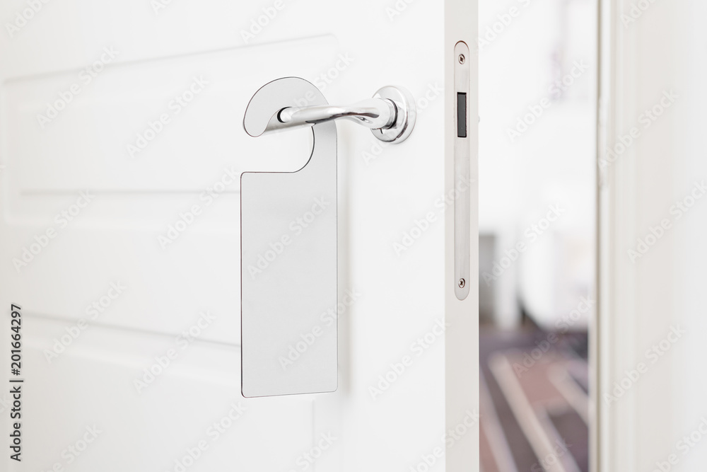 Door knob with empty label on a door handle for your text. Empty white