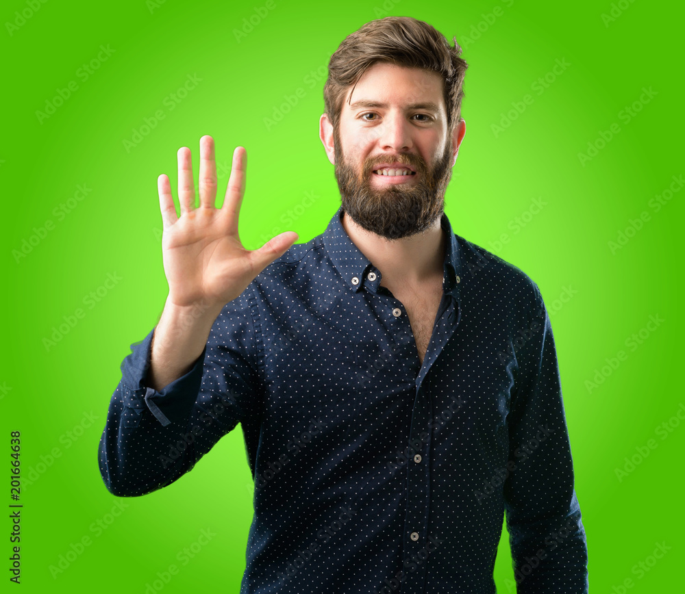 Young hipster man with big beard raising his finger, is the number five over green background Young hipster man with big beard raising his finger, is the number five over green background