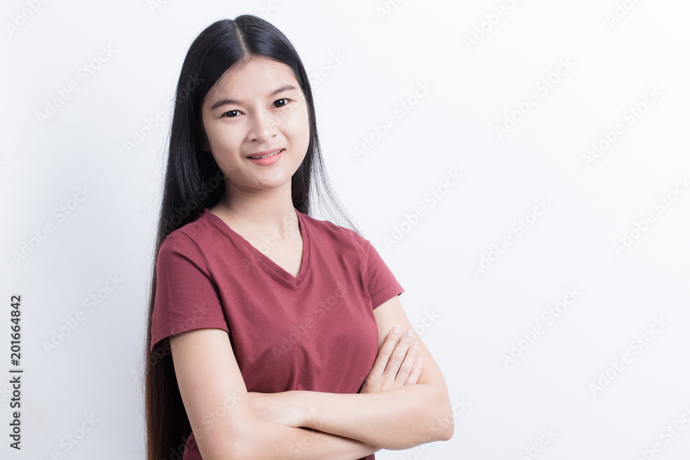 Obraz premium Asian girl standing and smiling with confidence on white background.