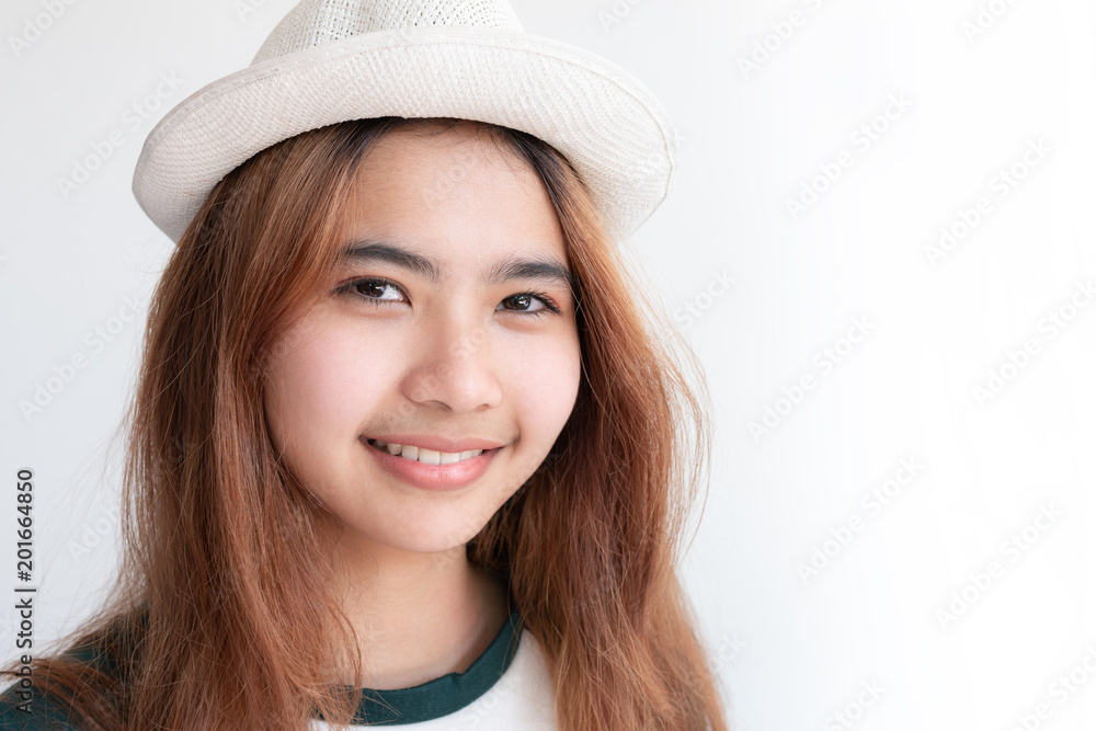 Asian girl wearing white hat smiling,Hipster young girl with smile on white background Asian girl wearing white hat smiling,Hipster young girl with smile on white background