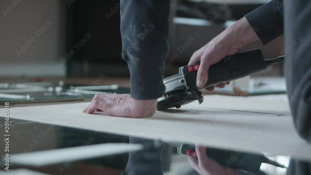 Male hands glueing square mirrors. Design, decoration and manual work concept. Male hands glueing square mirrors. Design, decoration and manual work concept.