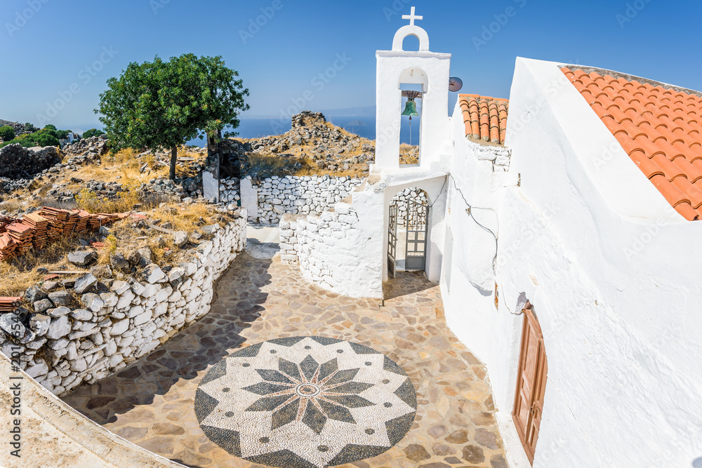 Holy greek chruch agios sant michael orthodox chapel monastery shining above the village Emporios over the greek sea on the edge of a volcano on the island of Nisyros, Kos, Dodecanese, Greece
