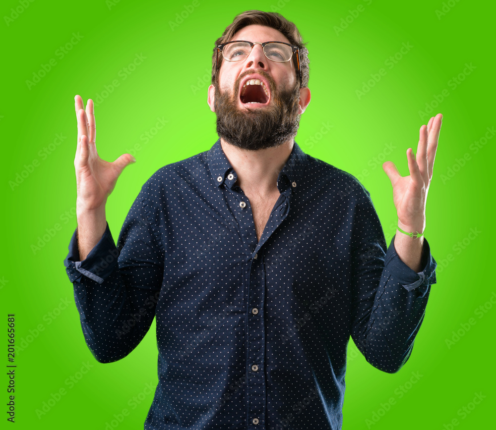 Young hipster man with big beard terrified and nervous expressing anxiety and panic gesture, overwhelmed over green background Young hipster man with big beard terrified and nervous expressing anxiety and panic gesture, overwhelmed over green background
