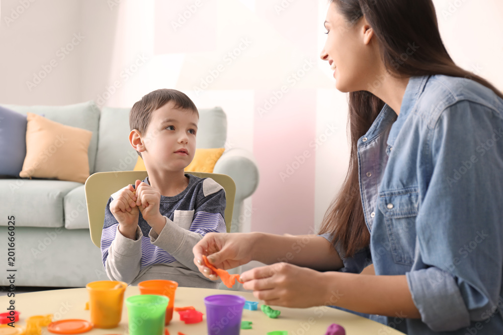 Nanny and little boy sculpting from plasticine at home Nanny and little boy sculpting from plasticine at home