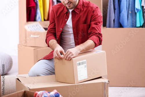 Man packing wardrobe boxes ...