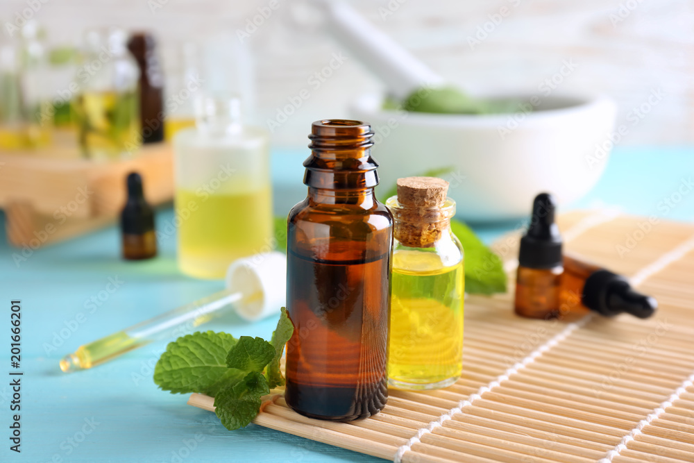 Bottles with essential oils on bamboo mat Bottles with essential oils on bamboo mat