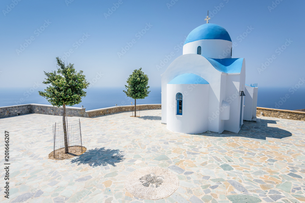 Holy greek white blue chruch chapel of agios theologos sant john shining above the village Nikia over the greek sea on the edge of a volcano on the island of Nisyros, Kos, Dodecanese, Greece