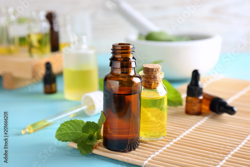 Bottles with essential oils on bamboo mat