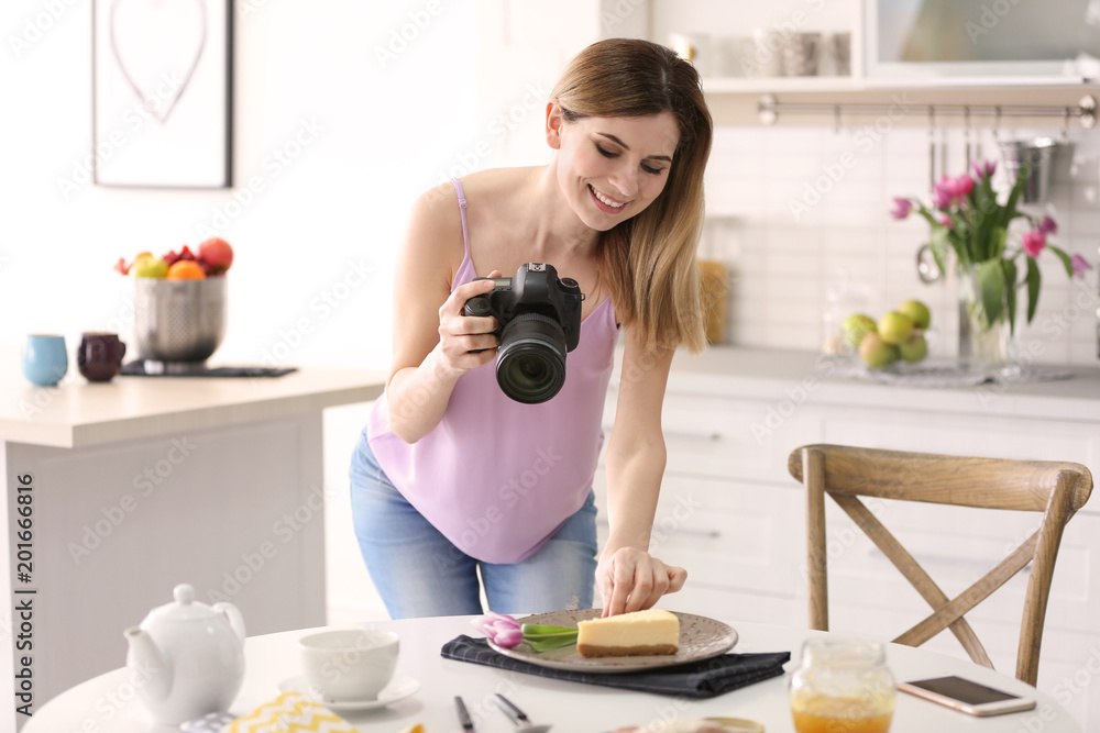 Young blogger taking photo of food in kitchen Young blogger taking photo of food in kitchen