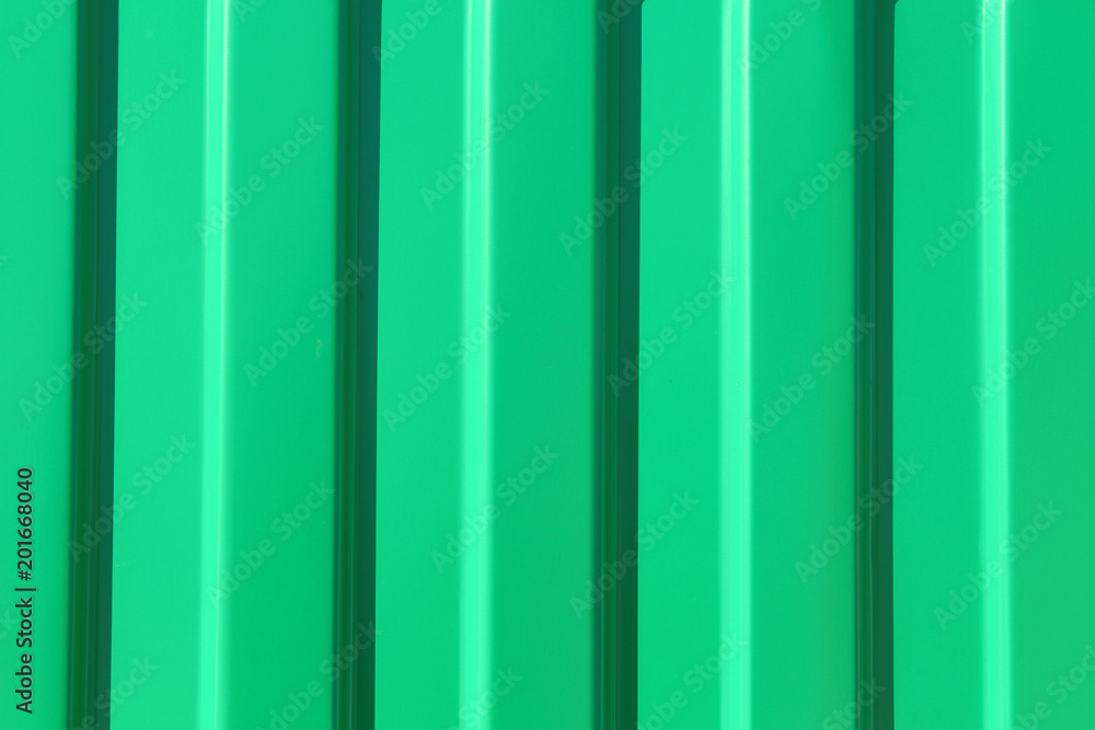 Green metal sheet of corrugated sheet. Close-up. Background. Texture. Green metal sheet of corrugated sheet. Close-up. Background. Texture.