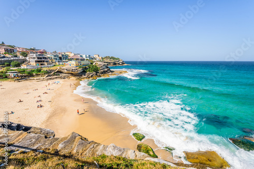 Obraz na płótnie Sunny beautiful summer coast view to Sydney beach and blue Tasman Sea wild wave water and sandy white beaches perfect for surfing swimming hiking, Coogee to Bondi Walk, NSW/ Australia - 10 11 2017 w salonie