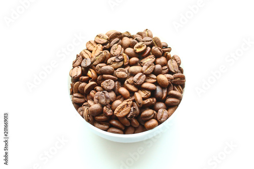 Coffee natural roasted in arabica beans in a bowl. Isolated on white background. Close-up.