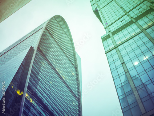 close up tall urban skyscrappers against the sky background