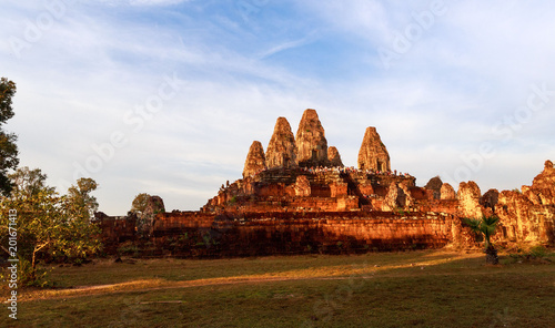 Tourists crowd atop one of the many ruins of ancient temples in the Angkor Wat complex, Cambodia