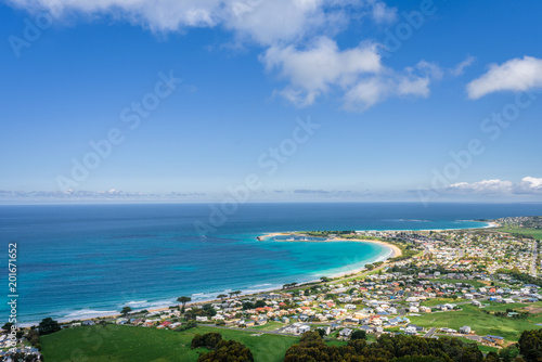 Relaxing at the blue Bass Strait sea and enjoying a warm sunny beach view over blue sky water of Great Ocean Road with a few clouds horizon over small town Apollo Bay, Melbourne, Victoria, Australia