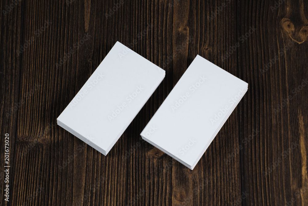 Blank business cards on wooden working table with copy space for add text ID. and logo, business company concept. Blank business cards on wooden working table with copy space for add text ID. and logo, business company concept.