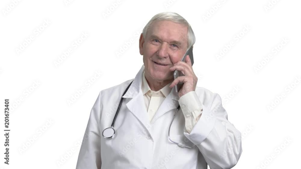 Handsome old doctor talking on the phone with one of his patients. Portrait of smiling cheerful physician in white isolated background. Handsome old doctor talking on the phone with one of his patients. Portrait of smiling cheerful physician in white isolated background.
