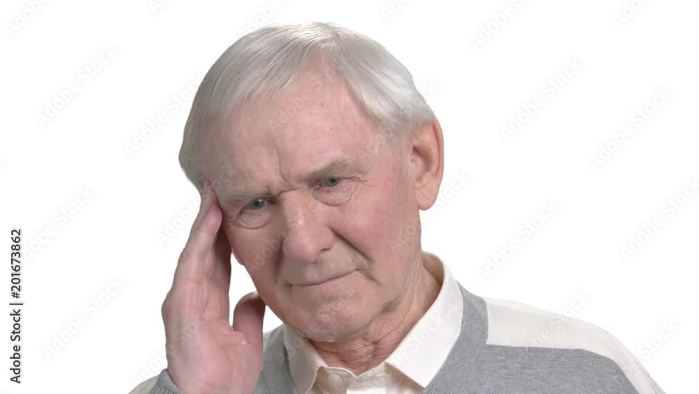 Aged man suffering from migraine. Grey haired man having pain in his temple, isolated on white background. Migraine and headache concept. Aged man suffering from migraine. Grey haired man having pain in his temple, isolated on white background. Migraine and headache concept.