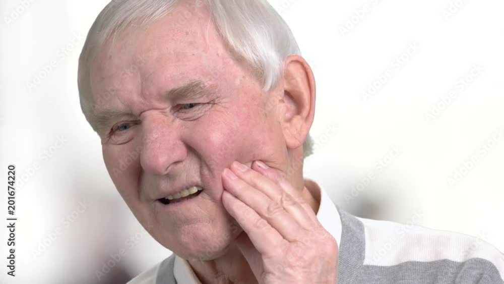 Elderly man suffering from strong tooth pain. Close up senior person suffering from painful teeth. Dental care and health, medical concept. Elderly man suffering from strong tooth pain. Close up senior person suffering from painful teeth. Dental care and health, medical concept.