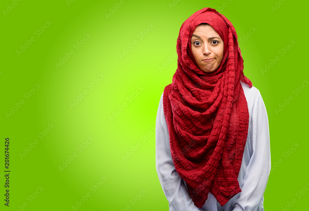 Young arab woman wearing hijab doubt expression, confuse and wonder concept, uncertain future Young arab woman wearing hijab doubt expression, confuse and wonder concept, uncertain future