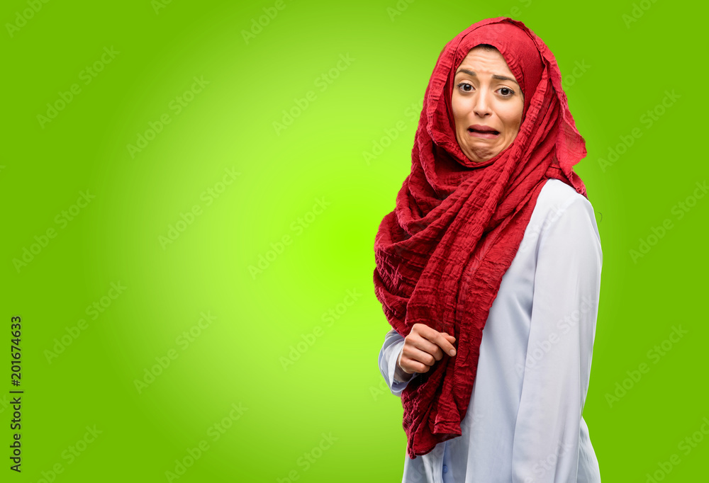 Young arab woman wearing hijab feeling disgusted with tongue out Young arab woman wearing hijab feeling disgusted with tongue out