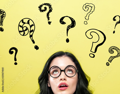 Question Marks with young woman on a yellow background