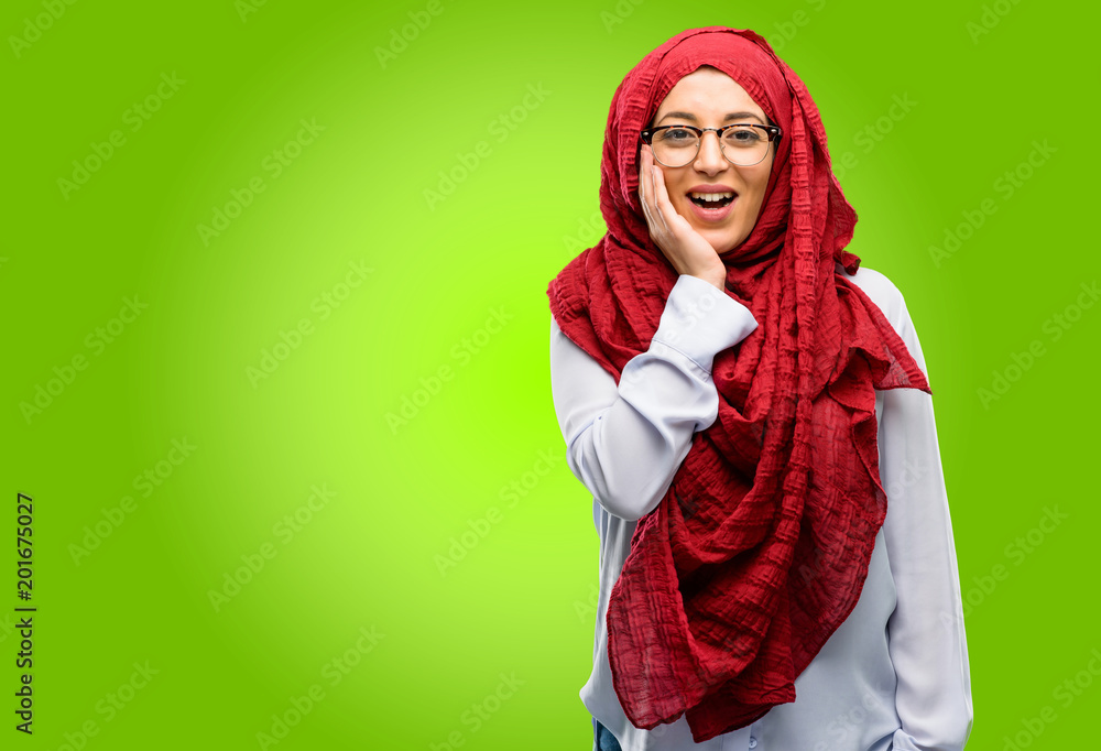 Young arab woman wearing hijab happy and surprised cheering expressing wow gesture Young arab woman wearing hijab happy and surprised cheering expressing wow gesture