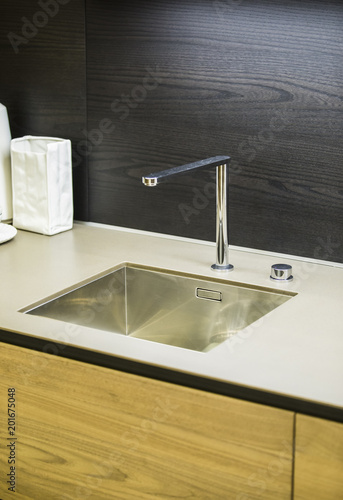 Water faucet in the modern kitchen. ?oncrete countertop and wooden kitchen