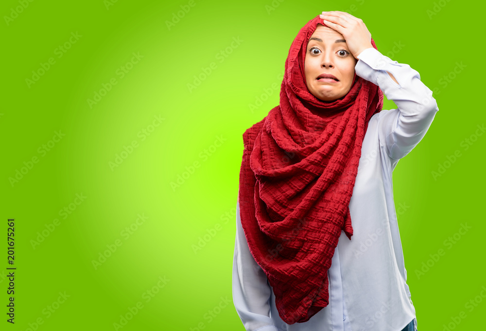 Young arab woman wearing hijab terrified and nervous expressing anxiety and panic gesture, overwhelmed Young arab woman wearing hijab terrified and nervous expressing anxiety and panic gesture, overwhelmed