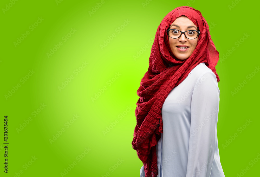 Young arab woman wearing hijab confident and happy with a big crazy smile laughing Young arab woman wearing hijab confident and happy with a big crazy smile laughing
