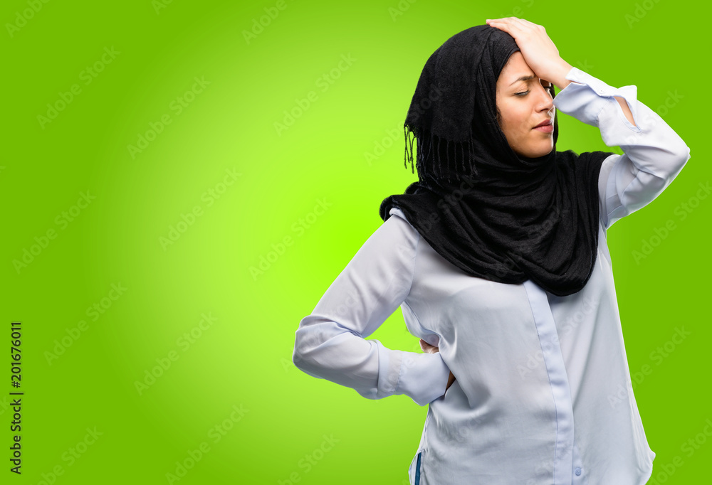 Young arab woman wearing hijab stressful keeping hand on head, tired and frustrated Young arab woman wearing hijab stressful keeping hand on head, tired and frustrated
