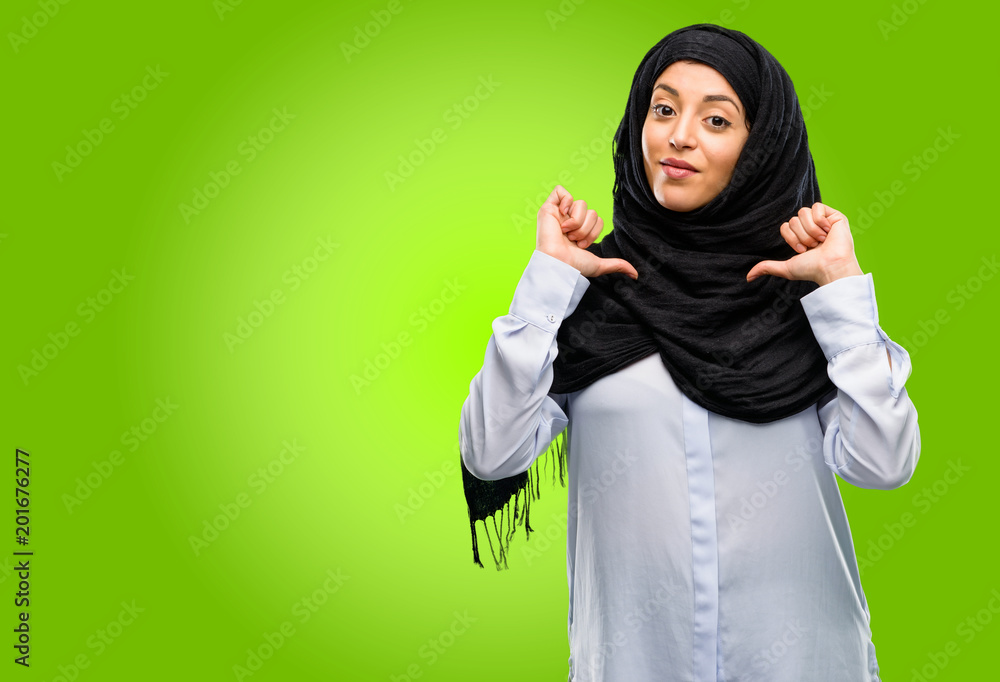 Young arab woman wearing hijab proud, excited and arrogant, pointing with victory face Young arab woman wearing hijab proud, excited and arrogant, pointing with victory face