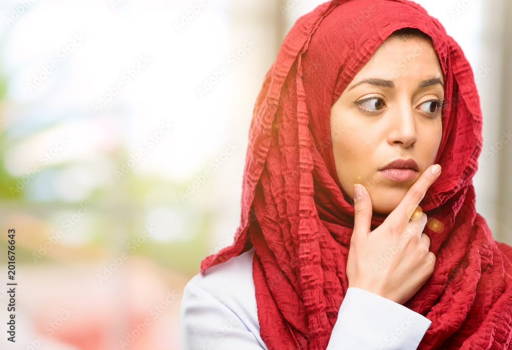 Young arab woman wearing hijab doubt expression, confuse and wonder concept, uncertain future Young arab woman wearing hijab doubt expression, confuse and wonder concept, uncertain future