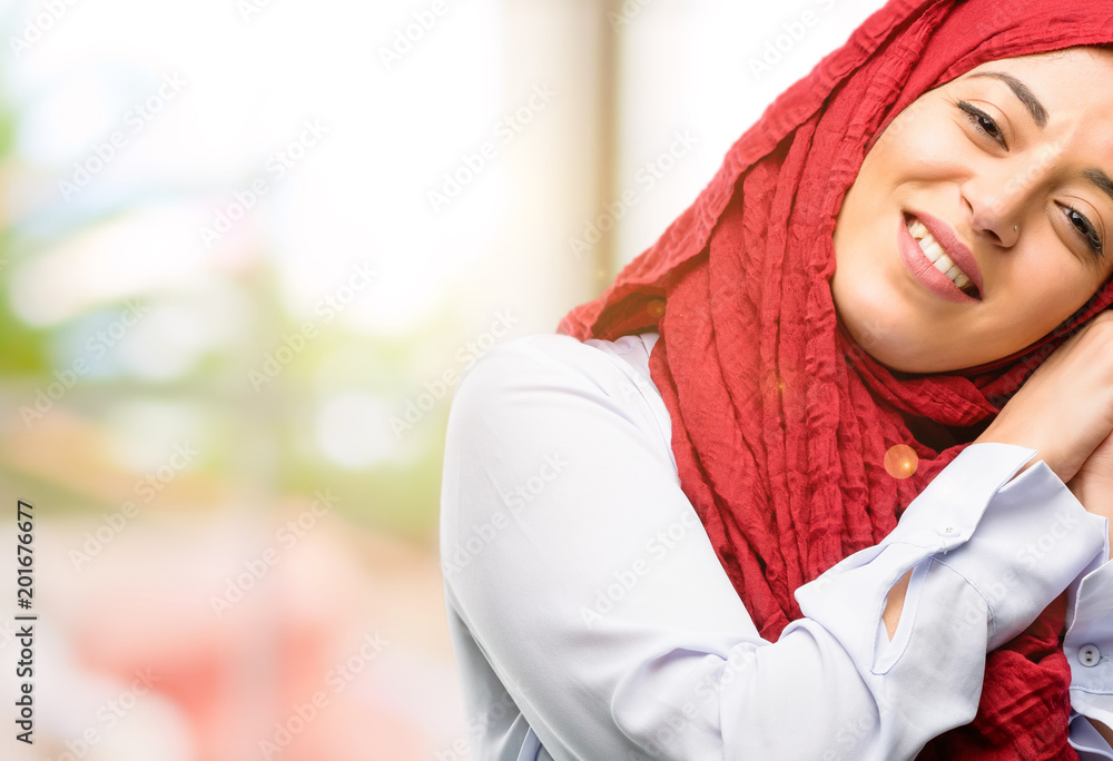 Young arab woman wearing hijab confident and happy with a big natural smile laughing Young arab woman wearing hijab confident and happy with a big natural smile laughing