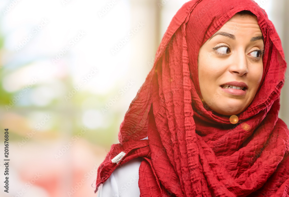 Young arab woman wearing hijab confident and happy with a big natural smile laughing Young arab woman wearing hijab confident and happy with a big natural smile laughing